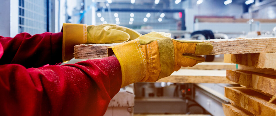 Carpenter with fibreboards at furniture factory workshop. Woodworking industry concept